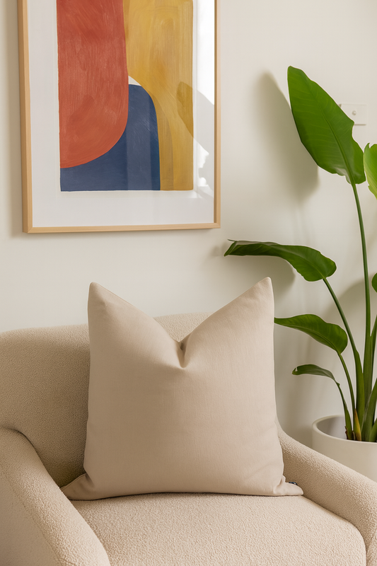 Stonewashed Beige Cushion on cream armchair with abstract artwork | interiors by zai