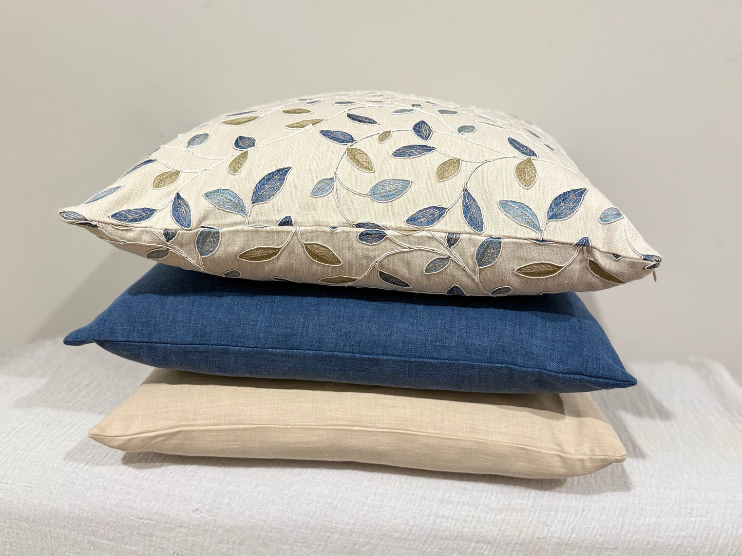 stacked cushions with Azure Olive Cushion paired with ink blue and stonewashed cushion | interiors by zai