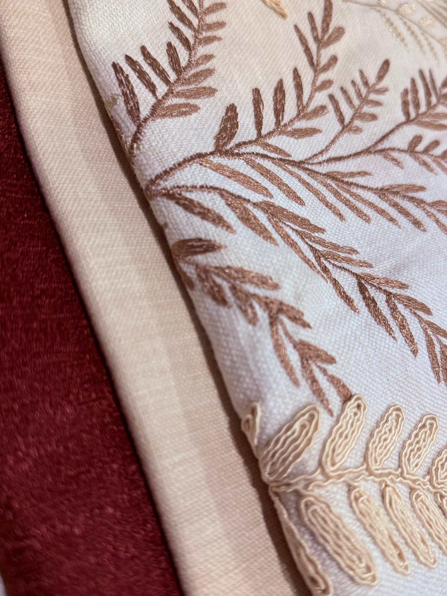 Close-up of the fabric of Willow Fern Cushion showing raised fern embroidery and colours