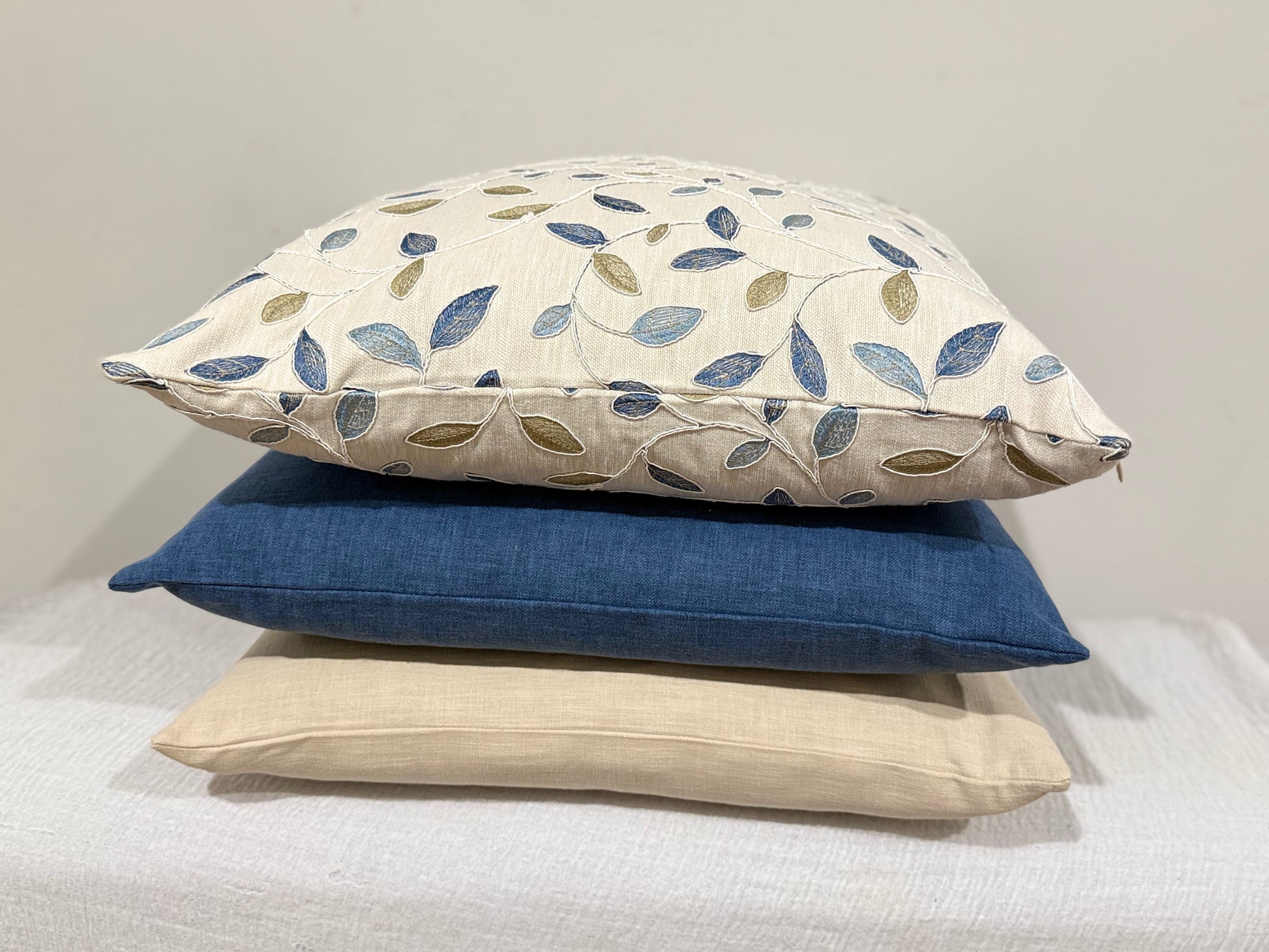 stacked cushions with Azure Olive Cushion paired with ink blue and stonewashed cushion | interiors by zai
