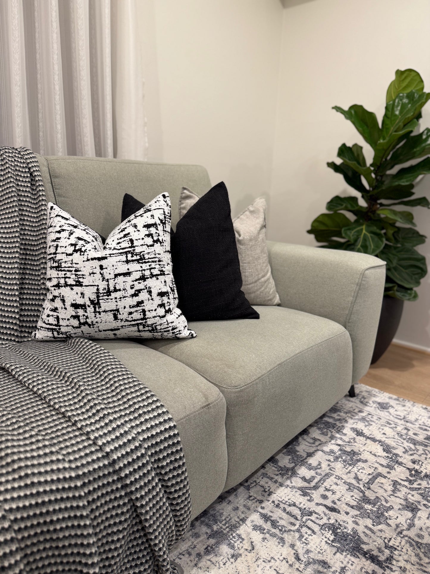 monochrome muse cushion layered with other cushions | interiorsbyzai
